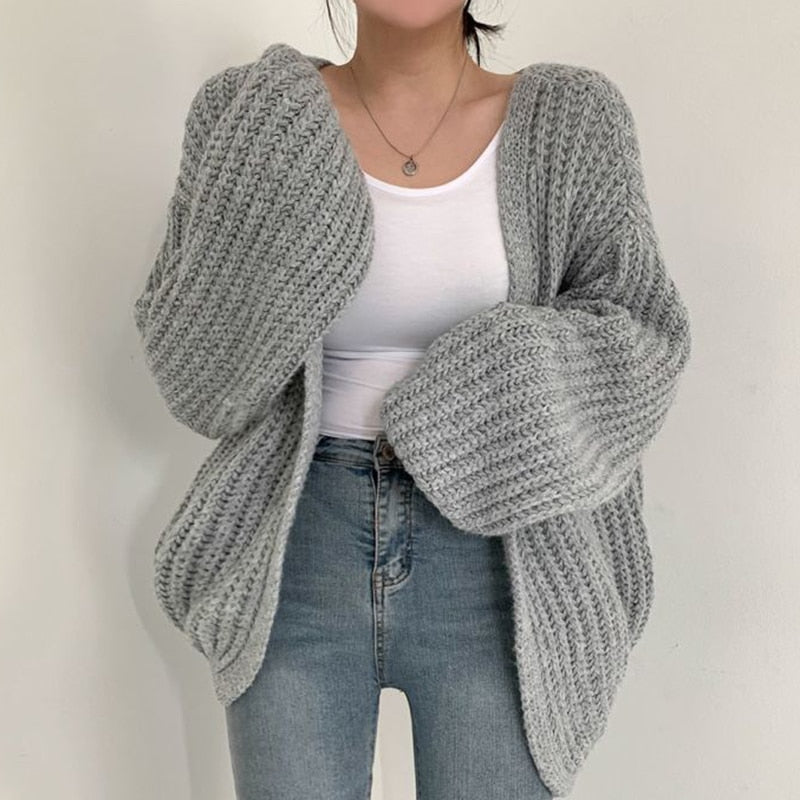 Soft women's chunky knit cardigan with trendy balloon sleeves. Relaxed fit for comfortable, casual fall layering.