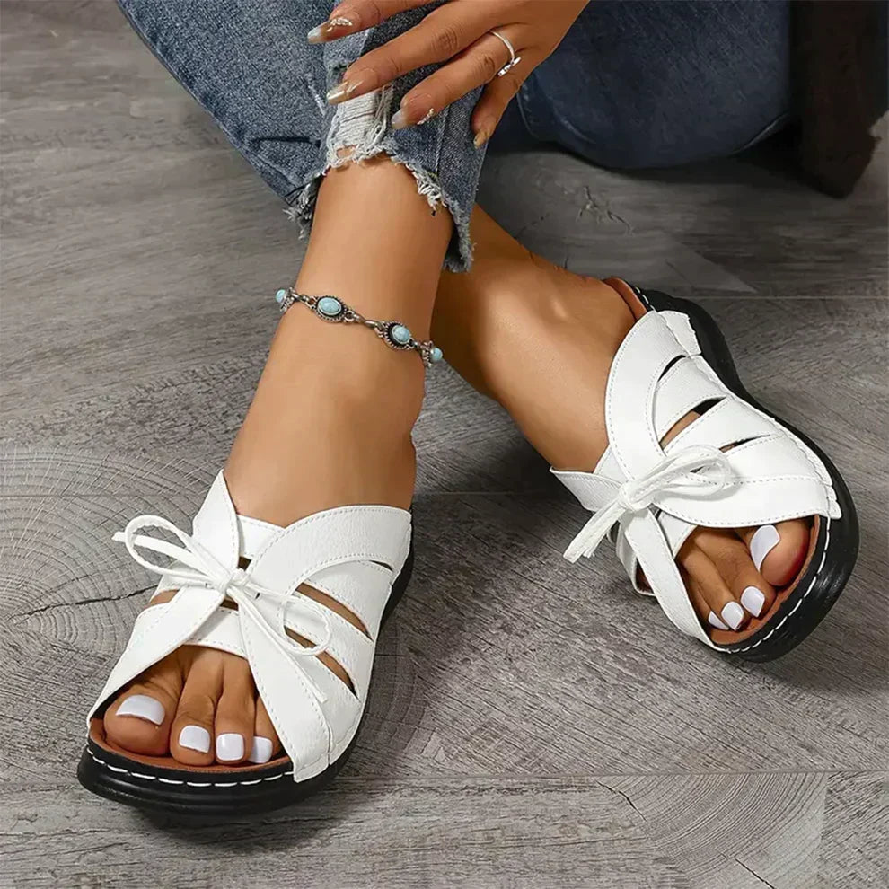 Summer women's wedge sandals with knot accent, providing comfortable and fashionable everyday wear.