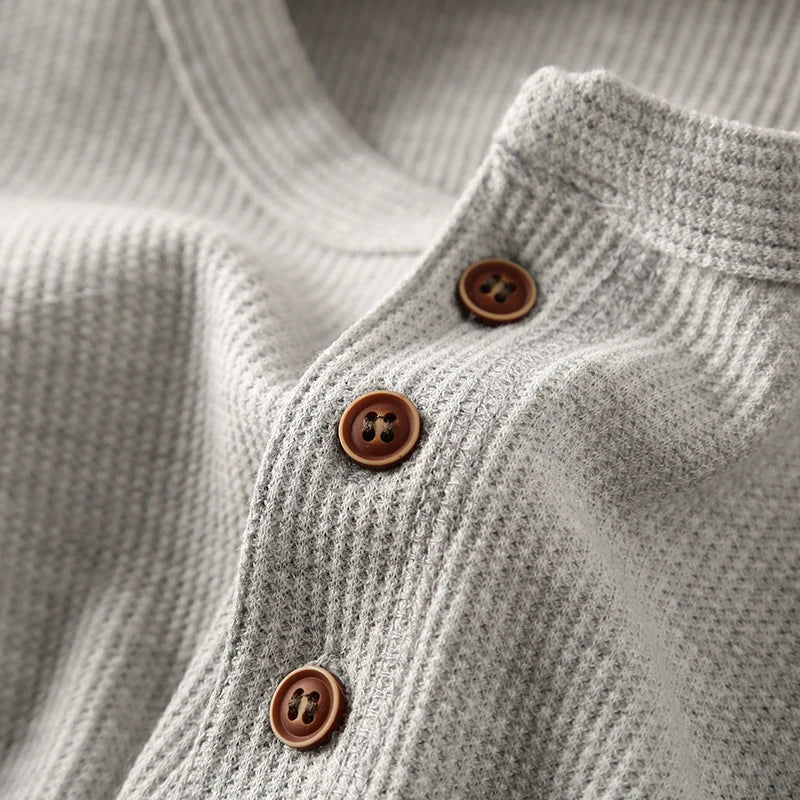 Minimalist men's henley featuring a soft waffle texture, ideal for smart casual looks.