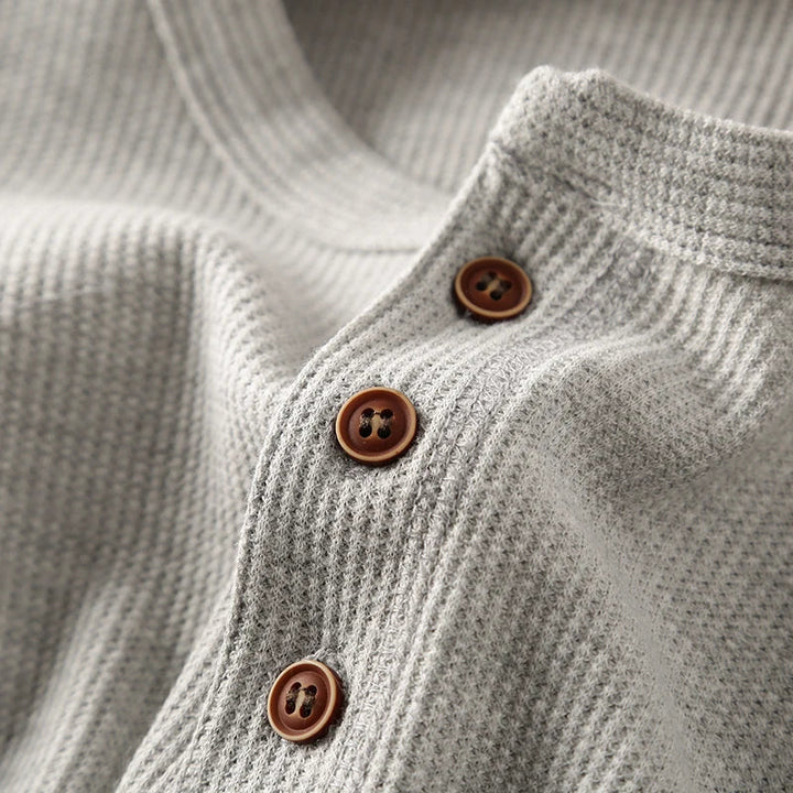 Minimalist men's henley featuring a soft waffle texture, ideal for smart casual looks.