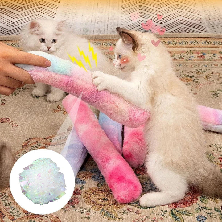 A happy kitten batting an interactive catnip plush pillow toy, ideal for playful stress relief.