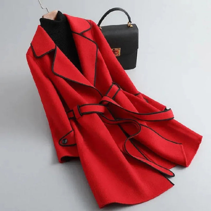 Smart women's tailored trench coat with belt, a sophisticated long layering piece for cold weather.