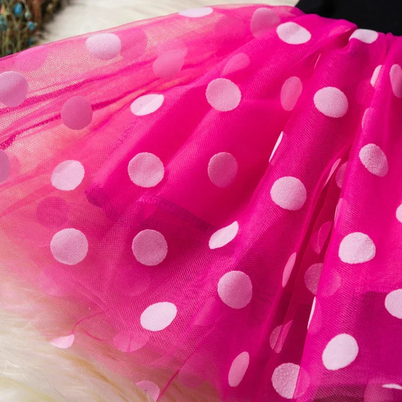 Young girl enjoying her Minnie Mouse polkadot dress & ears headband, ready for adventure.