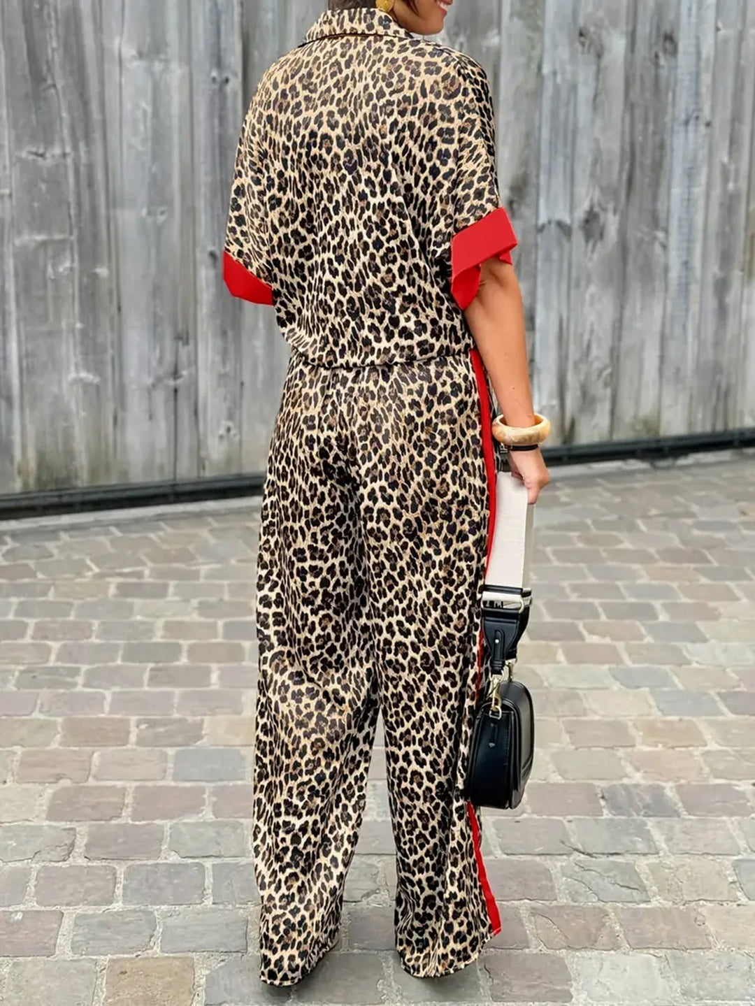 Elegant women's two-piece set with a collared top and wide-leg trousers. Perfect for casual chic or work.