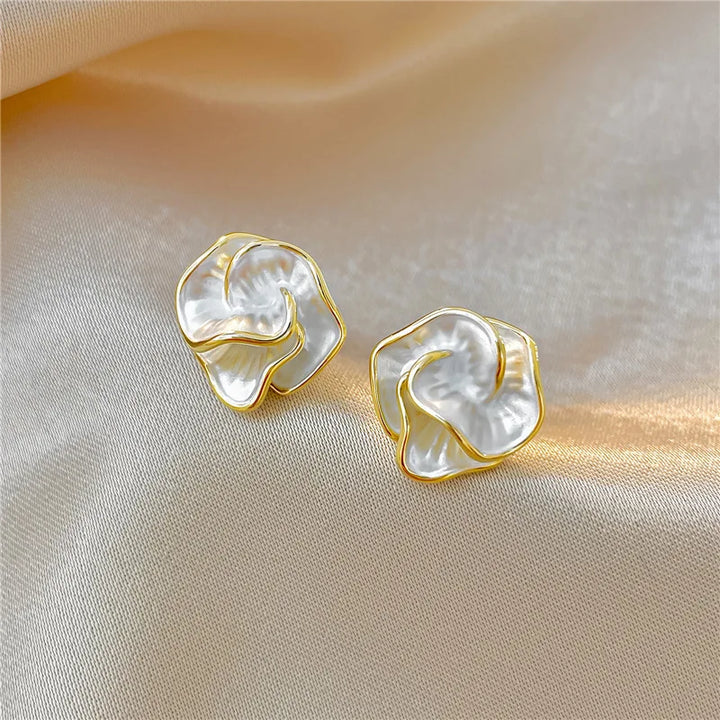 Close-up of elegant pearl flower drop earrings, highlighting delicate craftsmanship and shine.