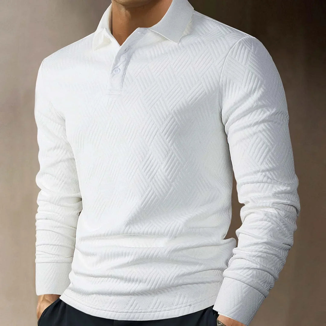 Close-up of the textured knit fabric on a men's long sleeve polo, showing its refined look.
