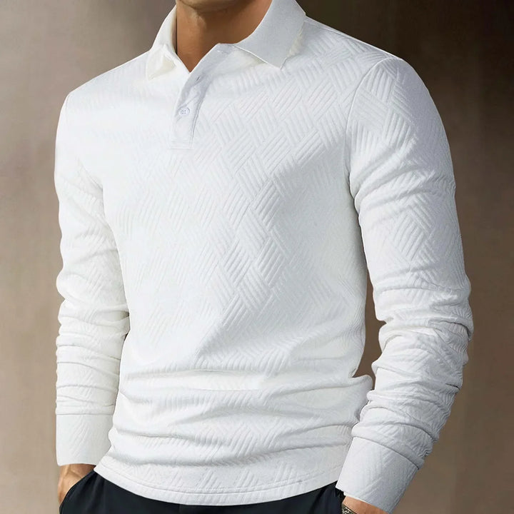 Close-up of the textured knit fabric on a men's long sleeve polo, showing its refined look.
