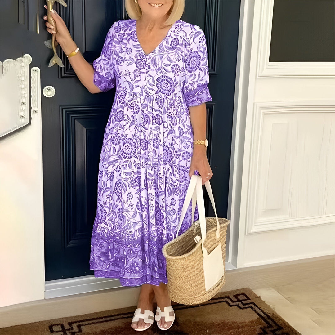 Close-up of the elegant V-neck and vibrant print on a women's bohemian maxi dress, perfect for summer style.