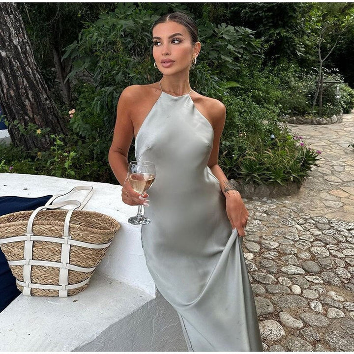 Women's sleeveless maxi dress with an elegant open back, perfect for formal occasions and evening events.
