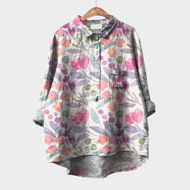 Printed women's blouse, Nola Collection, featuring long sleeves, button-up front, and round hem for casual wear.