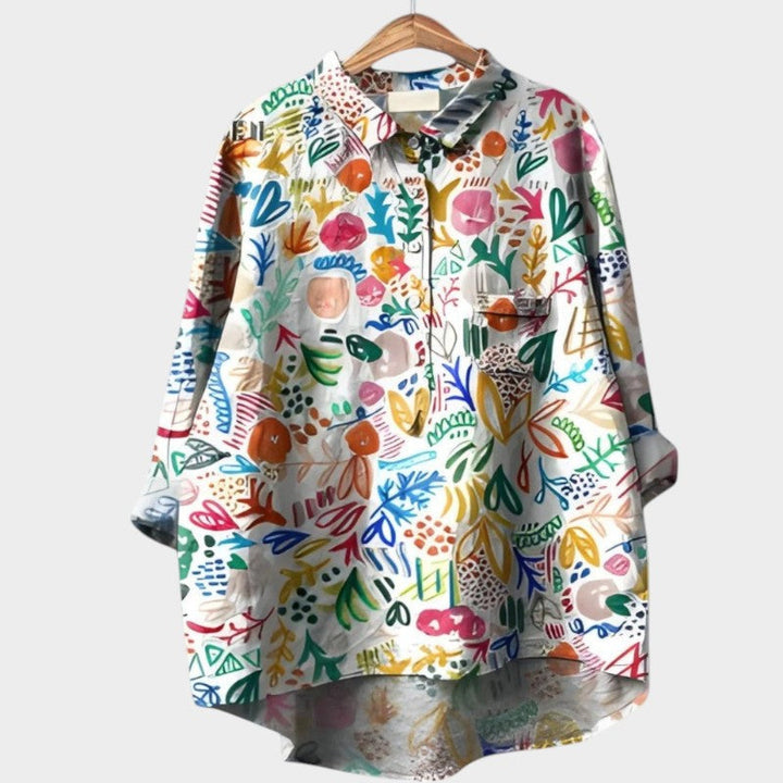 Stylish women's printed long-sleeve shirt from the Nola Collection, an elegant top with unique design details.