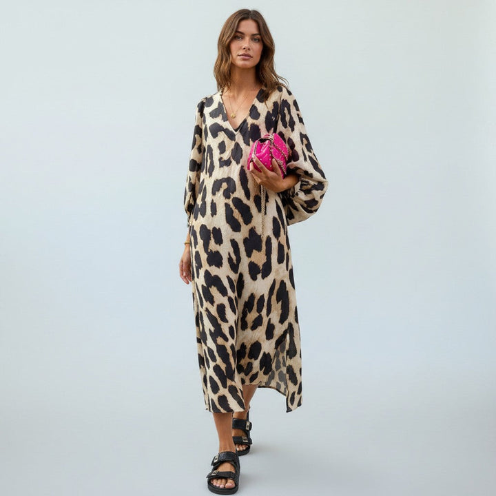 Women's flattering midi dress in a chic leopard print, ideal for an elegant feminine summer look.