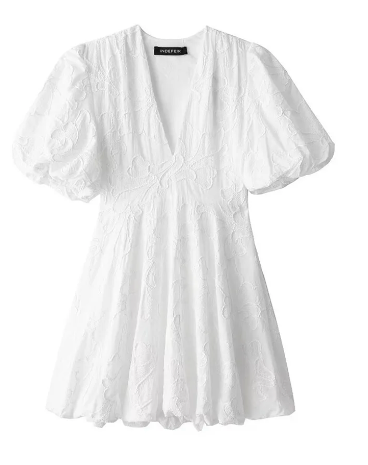 Stylish women's romantic floral mini dress, white, with puff sleeves, versatile for elegant or casual summer days.