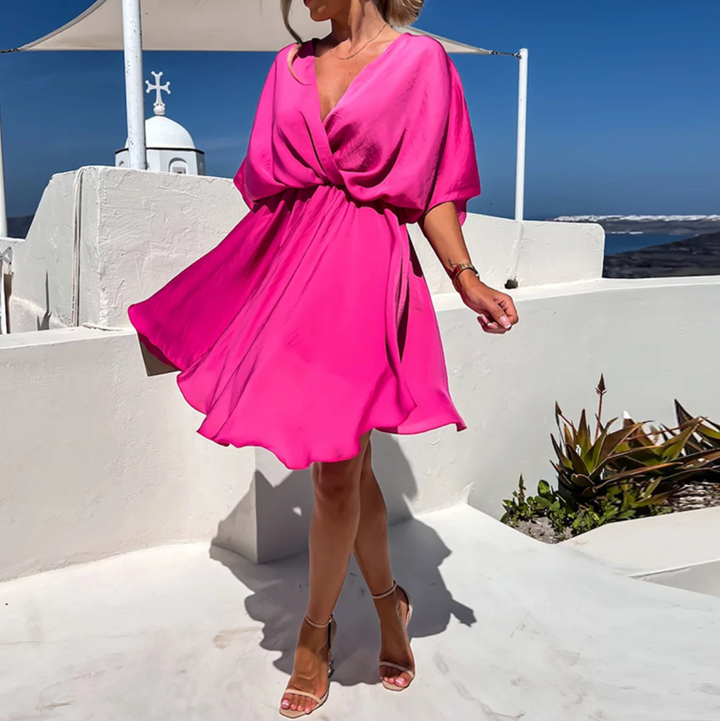 Flowy pink midi dress for women, an elegant summer dress perfect for holidays or casual chic.