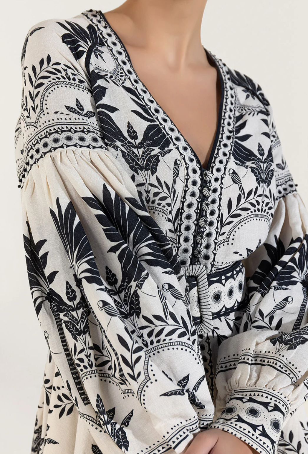 Stylish women's holiday mini dress in onyx black, featuring fashionable puffed sleeves and a flattering design.