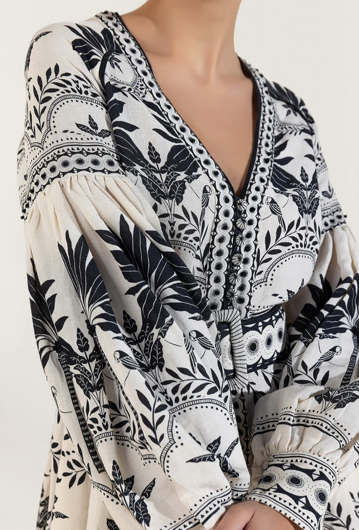Stylish women's holiday mini dress in onyx black, featuring fashionable puffed sleeves and a flattering design.