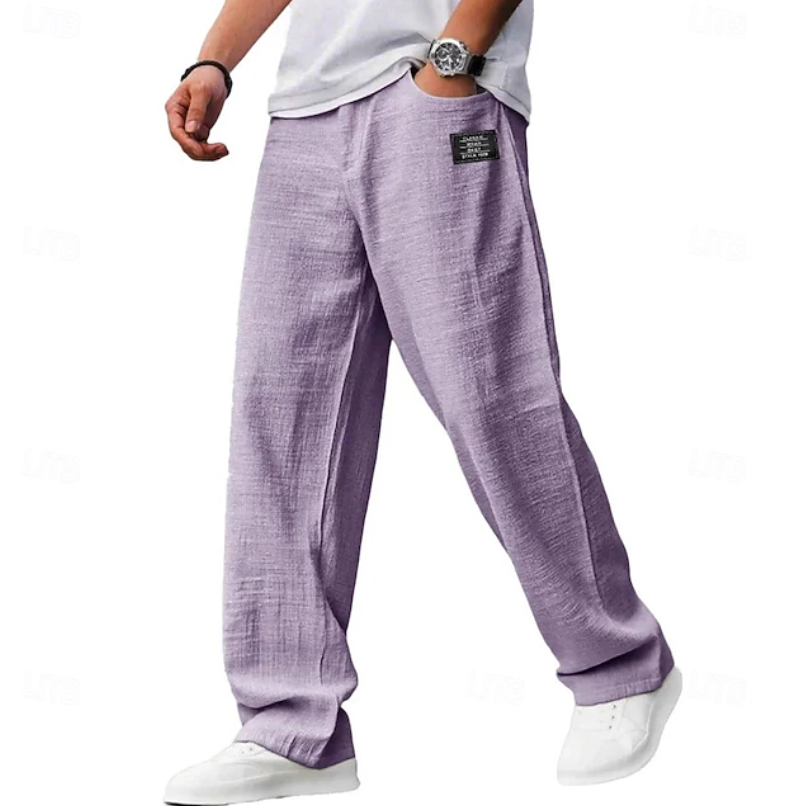 Man relaxing comfortably in loose fit casual pants, showcasing ease of movement for everyday wear.