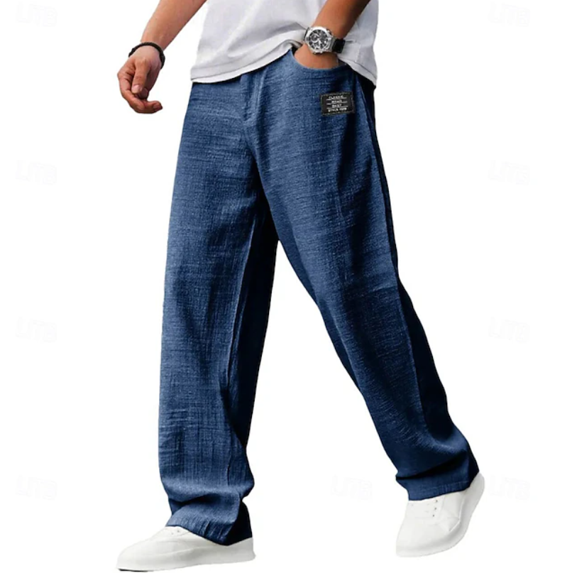 Neatly folded men's loose fit comfort trousers, ready for versatile everyday wear and casual styling.