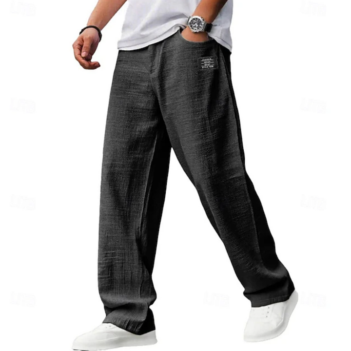 Side profile of men's loose fit comfort trousers, highlighting the relaxed silhouette and everyday style.