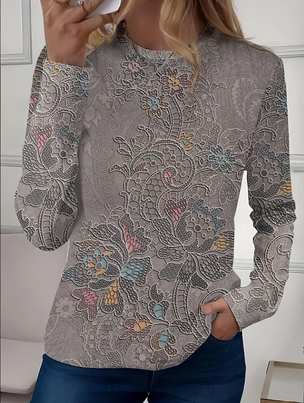 Woman wearing a chic casual floral long sleeve crew neck blouse. Ideal for a relaxed yet stylish everyday outfit.