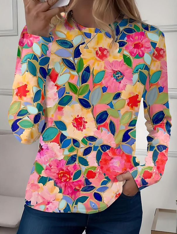 Stylish women's floral long sleeve blouse with crew neck. Features a vibrant, patterned design for a feminine look.