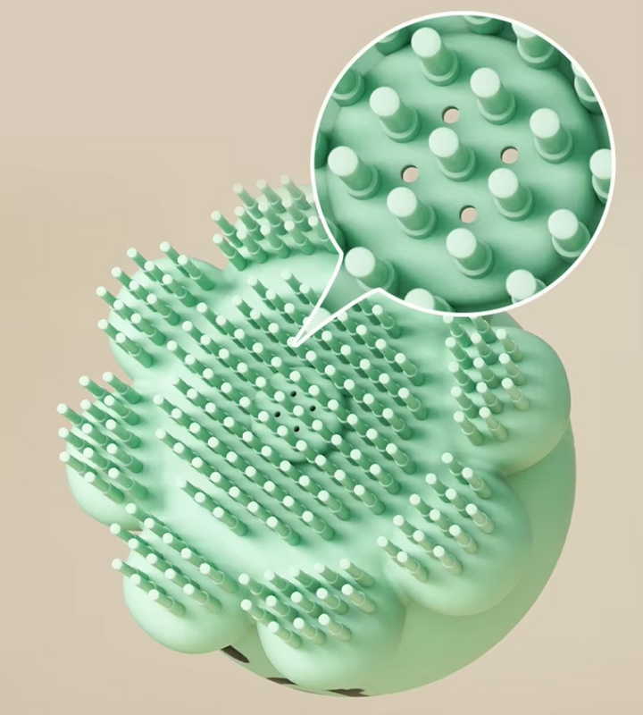 Pet grooming brush with foam dispenser for deep cleaning and detangling dog and cat fur during baths.
