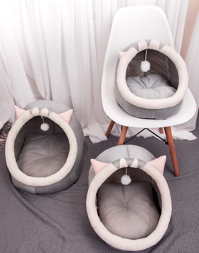 Plush igloo cat bed with soft material for ultimate comfort. Features playful cat ears & an interactive ball toy.