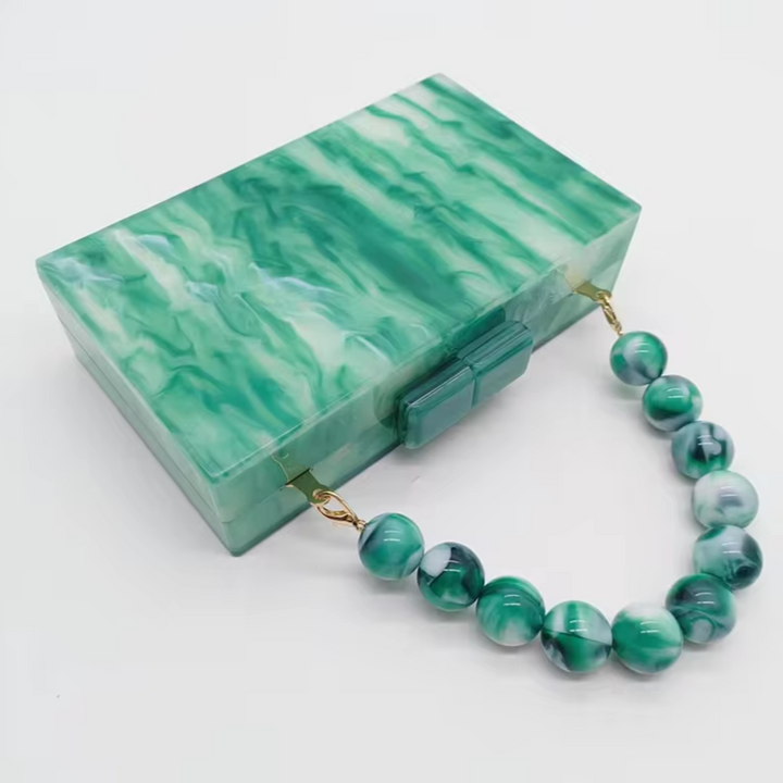 Luxurious acrylic party clutch, glamorous old money style women's handbag accessory.