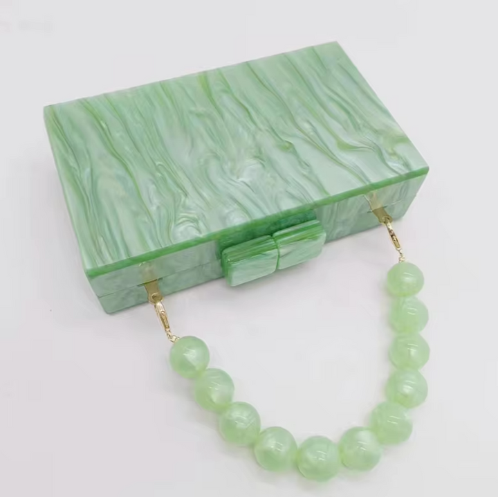 Modern acrylic clutch, elegant women's party bag for special occasion evening wear.