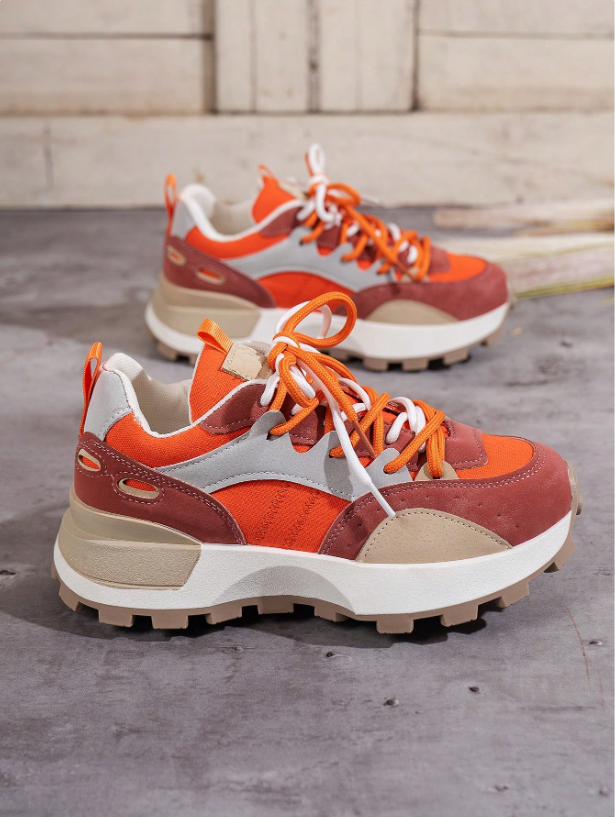 Close-up of women's trendy colourblock chunky platform lace-up sneakers, showcasing their unique design.