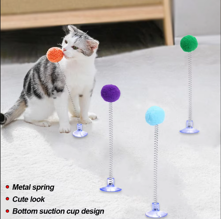 Feline entertainment: Cat's interactive suction cup toy for swatting, pouncing, promoting cat exercise.