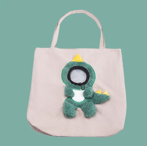 Small cat peeking from a funny animal costume pet carrier bag. Portable & safe travel bag for car journeys.