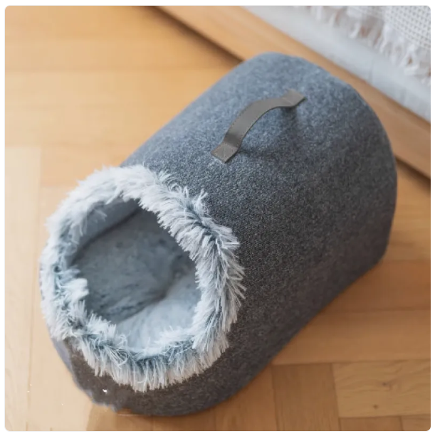 Stylish cat furniture: a cozy house bed with a fluffy edge, creating a perfect sleep haven for your pet.
