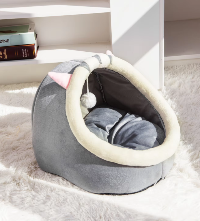 Cozy pet cave bed for cats, a soft igloo design with cute ears and an attached play ball. Ideal for rest & play.