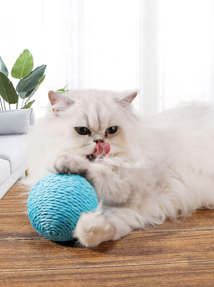 Round natural sisal scratch ball, an engaging cat toy for claw health & playful exercise.