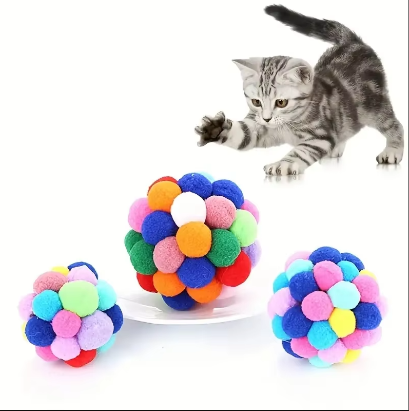 Vibrant pompom cat toy for house cats, a soft interactive ball promoting playful enrichment.