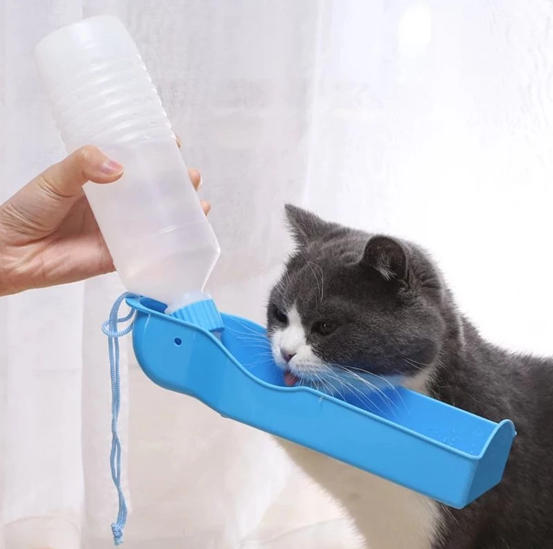 Portable dog water bottle & integrated travel bowl for on-the-go pet hydration.