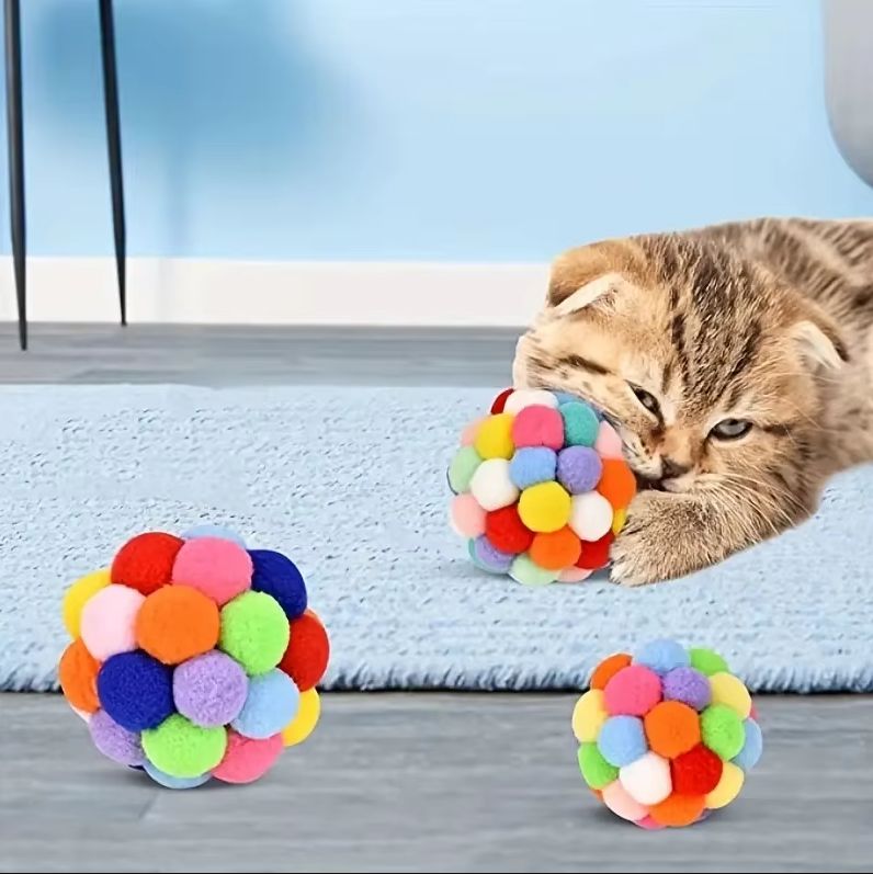 Soft colourful pompom cat ball, an engaging interactive toy for feline enrichment & playful pets.