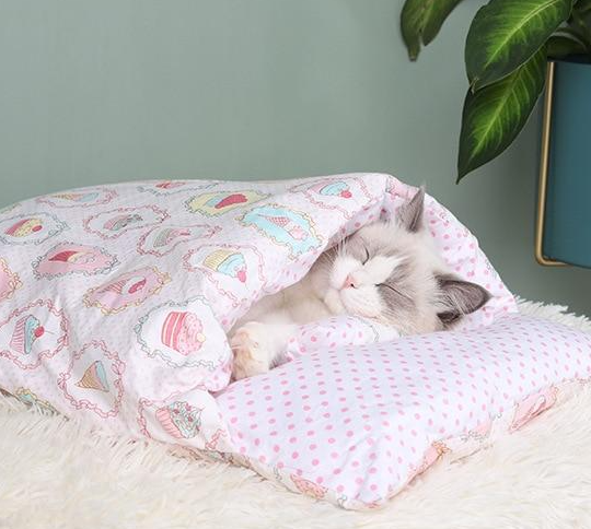 Cute cat sleeping bag bed, offering a snug retreat for cats & kittens. Comfortable, warm, and washable.