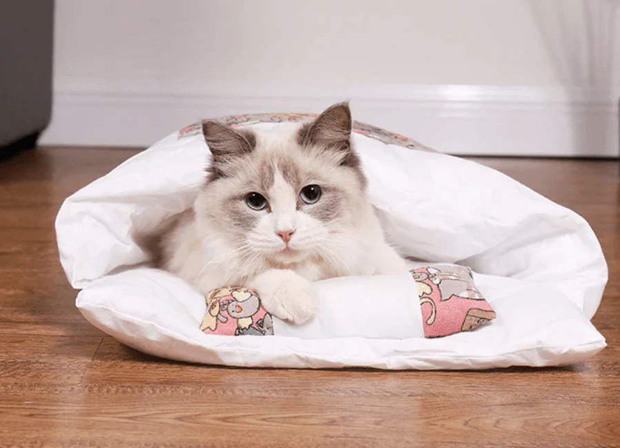 Plush cat sleeping bag and pet bed, designed for ultimate feline comfort. Ideal warm cat bed.