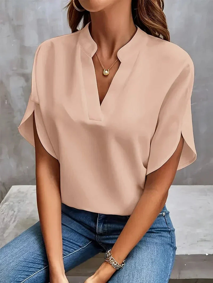 Chic women's fashion blouse: V-neck, loose fit, and elegant side slits for modern apparel.