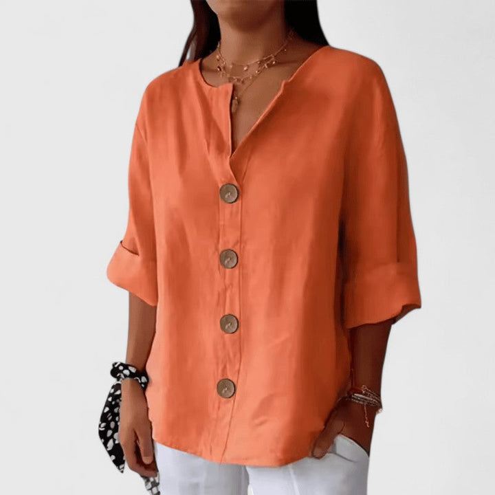 Woman wearing an elegant V-neck button-front blouse, showcasing its comfortable fit & versatile style.