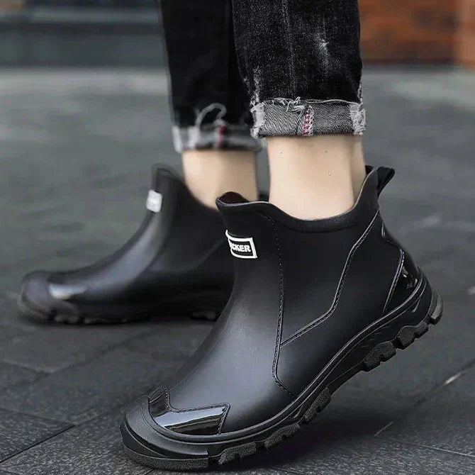 Close-up of men's waterproof outdoor ankle boots, showing rugged sole and sturdy laces.