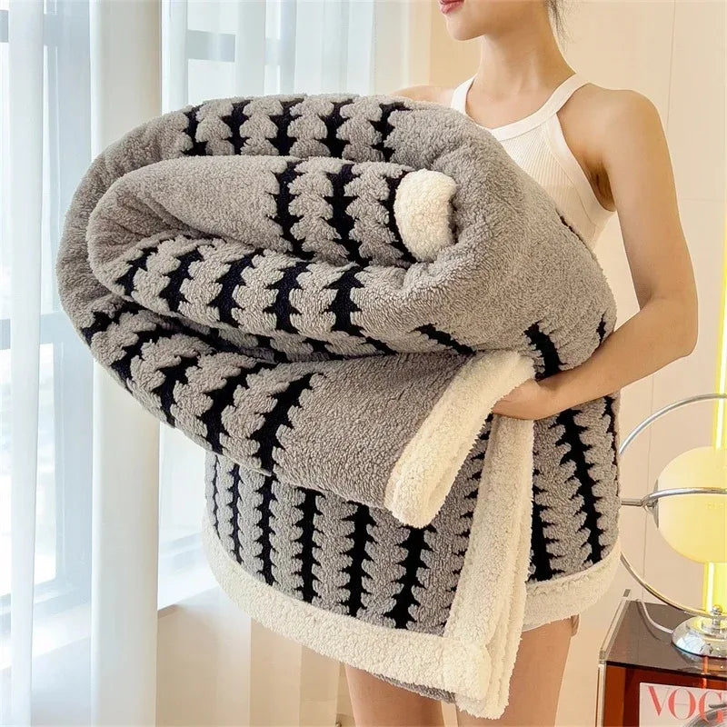 Modern geometric reversible throw blanket. Soft sherpa & warm, a stylish home decor piece.