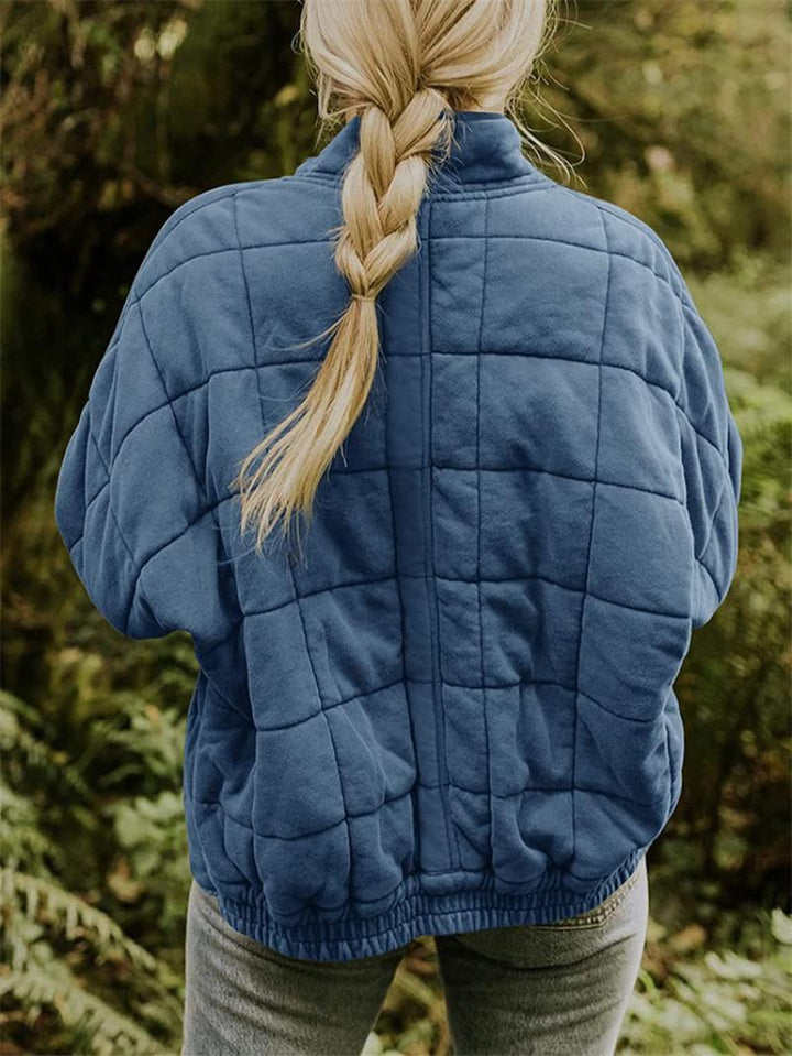Fashionable women's quilted jacket with a convenient zipper closure, great for light fall and spring layering.