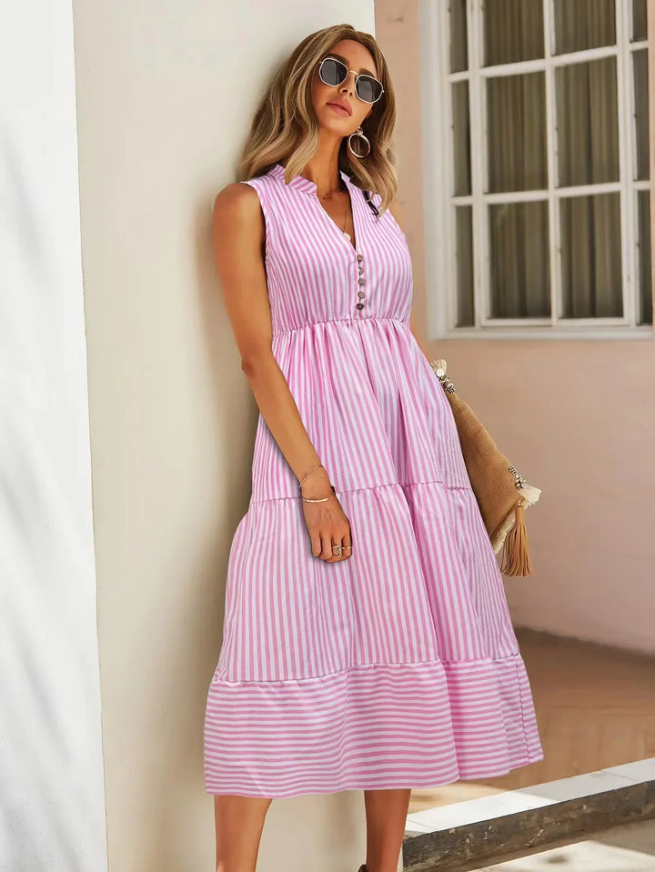 Trendy women's striped sleeveless midi dress. Chic, casual tiered button-down style for spring/summer fashion.