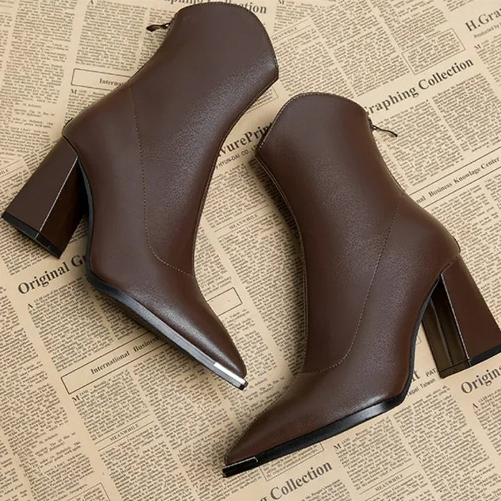 Fashionable women's ankle boots, sleek profile with a unique chrome toe, great for effortless style.