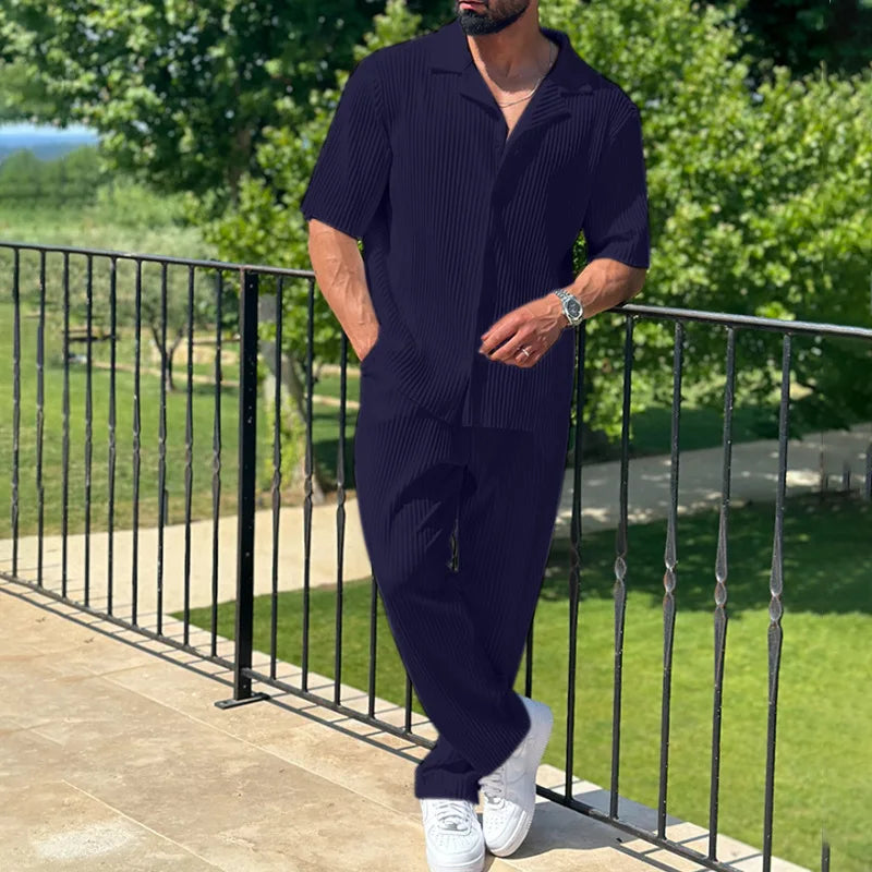 Complete men's pleated two-piece outfit with a short sleeve shirt & relaxed trousers, great for holiday style.