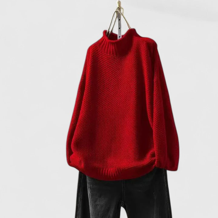 Woman relaxing in a chic casual textured mock neck sweater, perfect for cozy everyday winter wear.