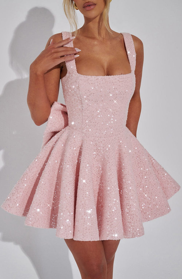 Stylish women's occasion wear: flared mini dress in pink, featuring a lovely bow detail.